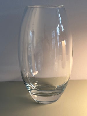 Vase, Glasvase, Stor og tung glasvase

Mål: 30 cm høj og 11 cm i diameter ved mundingen

Vasen er i 
