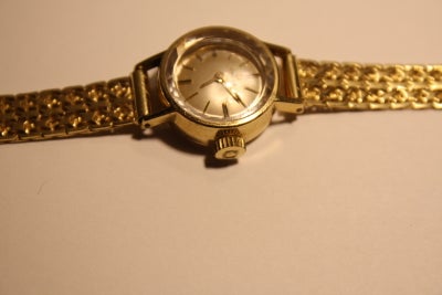 Dameur, Omega, Omega dame ur i 14 karat guld, diameter 1,8 cm + optrækker knoppen. Uret er med en fi
