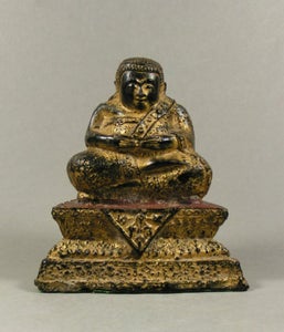 A gilded bronze, partly red lacquered sculpture of the Mahākātyāyana Buddha, ...
